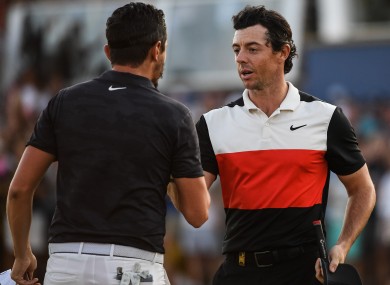 Rory McIlroy shakes hands with Mike Lorenzo-Vera after finishing on the 18th green in round two of the DP World Tour Championship in Dubai.