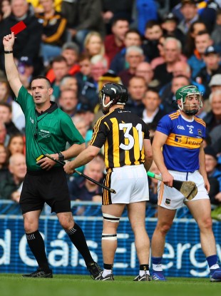 Referee James Owens shows a red card to Richie Hogan.