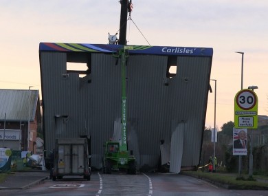 A recovery crane removing the forecourt roof after the raid at Carlisle's filling station early this morning.