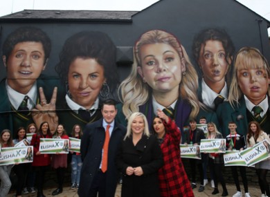 Sinn Fein John Finucane, candidate Elisha McCallion and Vice President of Sinn Fein Michelle O’Neill beside a mural of the Derry Girls.