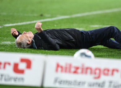 Christian Streich pictured on the ground after being pushed over by David Abraham.