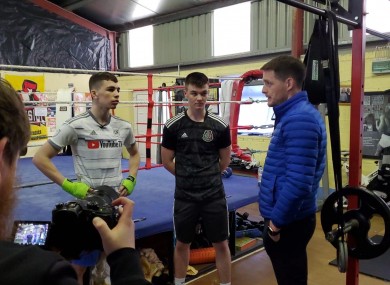 Aaron McKenna (centre) and his brother, Stevie, speak with Monaghan Gaelic football star Conor McManus in their back-garden gym in Smithborough, Monaghan.