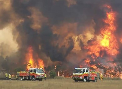 Firefighters trying to protect homes around Charmhaven, New South Wales.