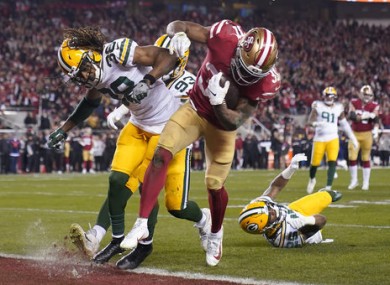 San Francisco 49ers running back Raheem Mostert, center right, scores a touchdown next to Green Bay Packers cornerback Tramon Williams.