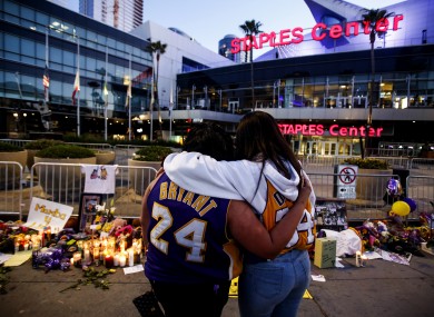 Fans pay their respects outside the LA Lakers stadium.