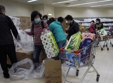 Customers wearing masks, purchase tissue papers in a supermarket in Hong Kong.