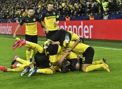 Haaland is mobbed by team-mates after scoring.