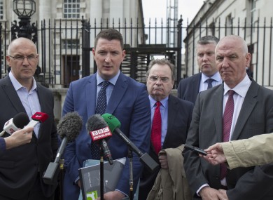 John Finucane, son of Pat Finucane, with his uncles Seamus Finucane (left of group) and Martin Finucane (right of group).
