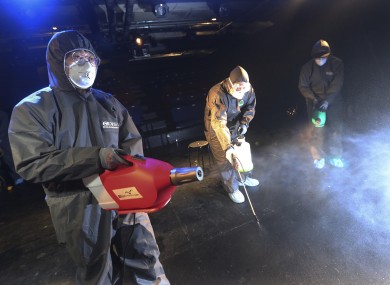 File photo. Workers in Korea disinfect a local theatre.