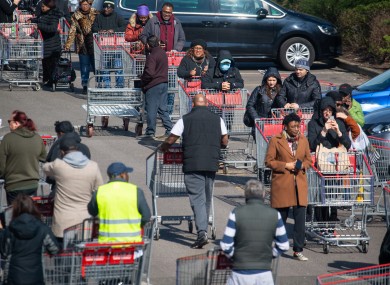Shoppers queue outside a branch of Costco, in Croydon, south London.