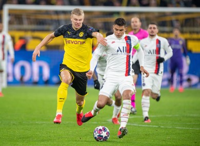 Erling Haaland and Thiago Silva chase a ball in the first leg.