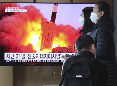 People pass by a TV screen in Seoul, South Korea.