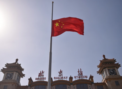 A flag at half mast in Beijing as China continues its battle against the Covid-19 virus.