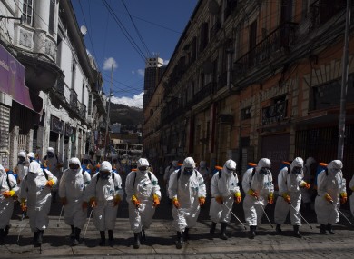 City workers fumigate a street to help contain the spread of the new coronavirus in La Paz, Bolivia.