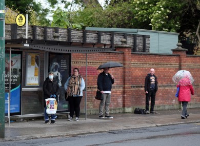 People waiting for a bus in Dublin this morning.