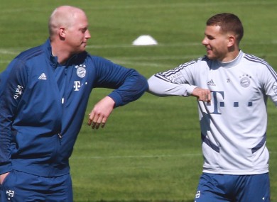 Lucas Hernandez (right) bumps elbows with a Bayern Munich physio.