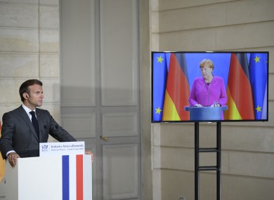 Macron (in Paris) giving a press conference with Merkel (in Berlin) earlier today.