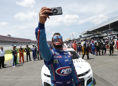 Drivers rally around Wallace yesterday.