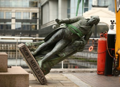 Workers prepare to take down a statue of slave owner Robert Milligan at West India Quay, east London.