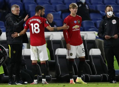 Manchester United's manager Ole Gunnar Solskjaer, left, congratulates Manchester United's Bruno Fernandes as he leaves the pitch.