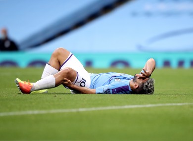 Sergio Aguero holds his knee after sustaining the injury.