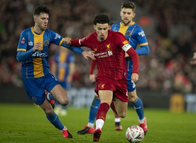 Liverpool's Curtis Jones (R) gets away from Shrewsbury Town's Sean Goss during the English FA Cup 4th Round Replay match.
