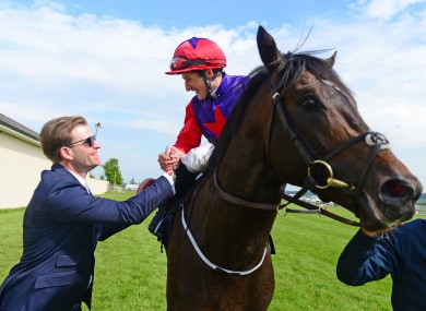 Romanised and jockey Shane Foley are greeted by winning trainer Ken Condon.