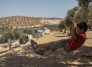 A child a swing he made in a camp in Idlib, northern Syria.