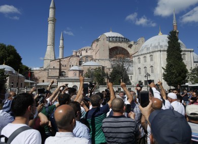 People chant slogans following Turkey's Council of State's decision, outside the Byzantine-era Hagia Sophia.