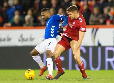 Tommie Hoban tangling with Jermain Defoe while playing for Aberdeen against Rangers in February 2019.