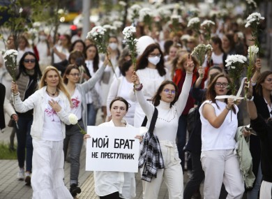 Belarusian women, one of them carrying a sign that reads 'My brother is not a criminal', march in Minsk today in solidarity with protesters injured in the latest rallies.