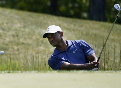 Tiger Woods makes his first attempted shot out of a trap on the fourteenth tee during the third round of the Northern Trust golf tournament.