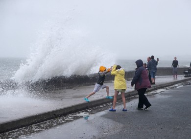 People are hit by waves on the Front Strand in Youghal, Co Cork, on Wednesday.