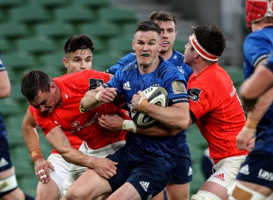 Johnny Sexton of Leinster is tackled by Munster's Tommy O'Donnell and Billy Holland during the sides' recent meeting.