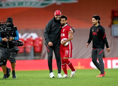 Jurgen Klopp hugs Mo Salah at the final whistle yesterday.