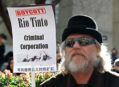 Protesters are seen during a rally outside the Rio Tinto office in Perth in June.