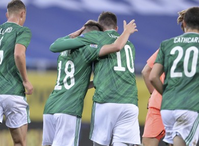 Northern Ireland's Gavin Whyte, second from left, celebrates after scoring.