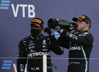 Race winner, Mercedes driver Valtteri Bottas of Finland, right, drinks champagne with third placed Mercedes driver Lewis Hamilton of Britain after the Russian Formula One Grand Prix.