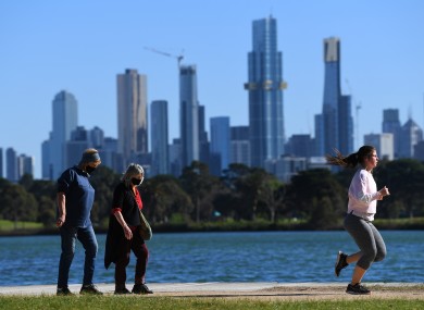 People are seen exercising along Albert Park Lake in Melbourne