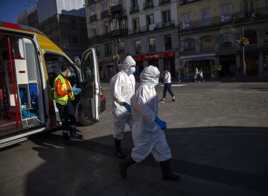 Health workers walk at the Puerta del Sol in Madrid, Spain, last Friday.