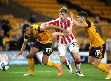 Stoke City's Nathan Collins tangles with Romain Saiss and Ruben Vinagre of Wolves.