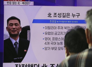 People watch a TV showing an image of Jo Song Gil, the North Korea's former ambassador to Italy, during a news programme at the Seoul Railway Station.