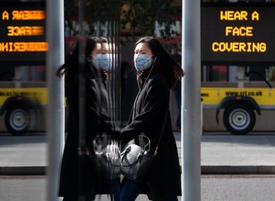 A woman wearing a protective face mask in central London