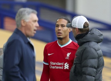 Liverpool manager Jurgen Klopp checks on Virgil van Dijk as he leaves the field during the game against Everton.