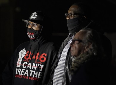 Terrence Floyd, brother of George Floyd, Rev. Kevin McCall, and Sandy Rubenstein watch election night results, Tuesday.