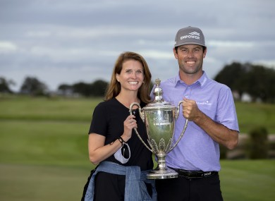Robert Streb and his wife Maggie Streb hold aloft the RSM Classic trophy.