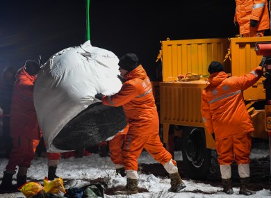 Staff members transport the return capsule of China's Chang'e-5 module