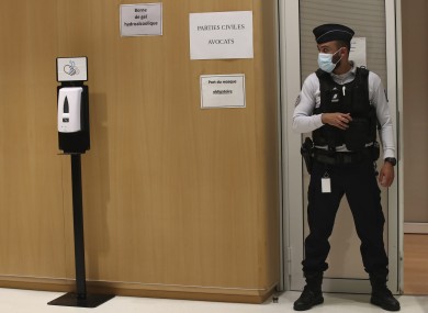 A police officier guards the courtroom at the Paris Hall of Justice today