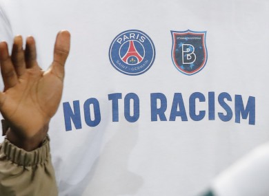 A 'No To Racism' logo on the shirt of Basaksehir assistant coach Pierre Webo.