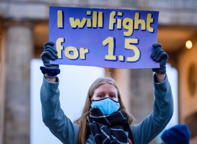 A climate protester in Berlin yesterday. Her poster references the 1.5 degree Celsius target of the Paris climate agreement.